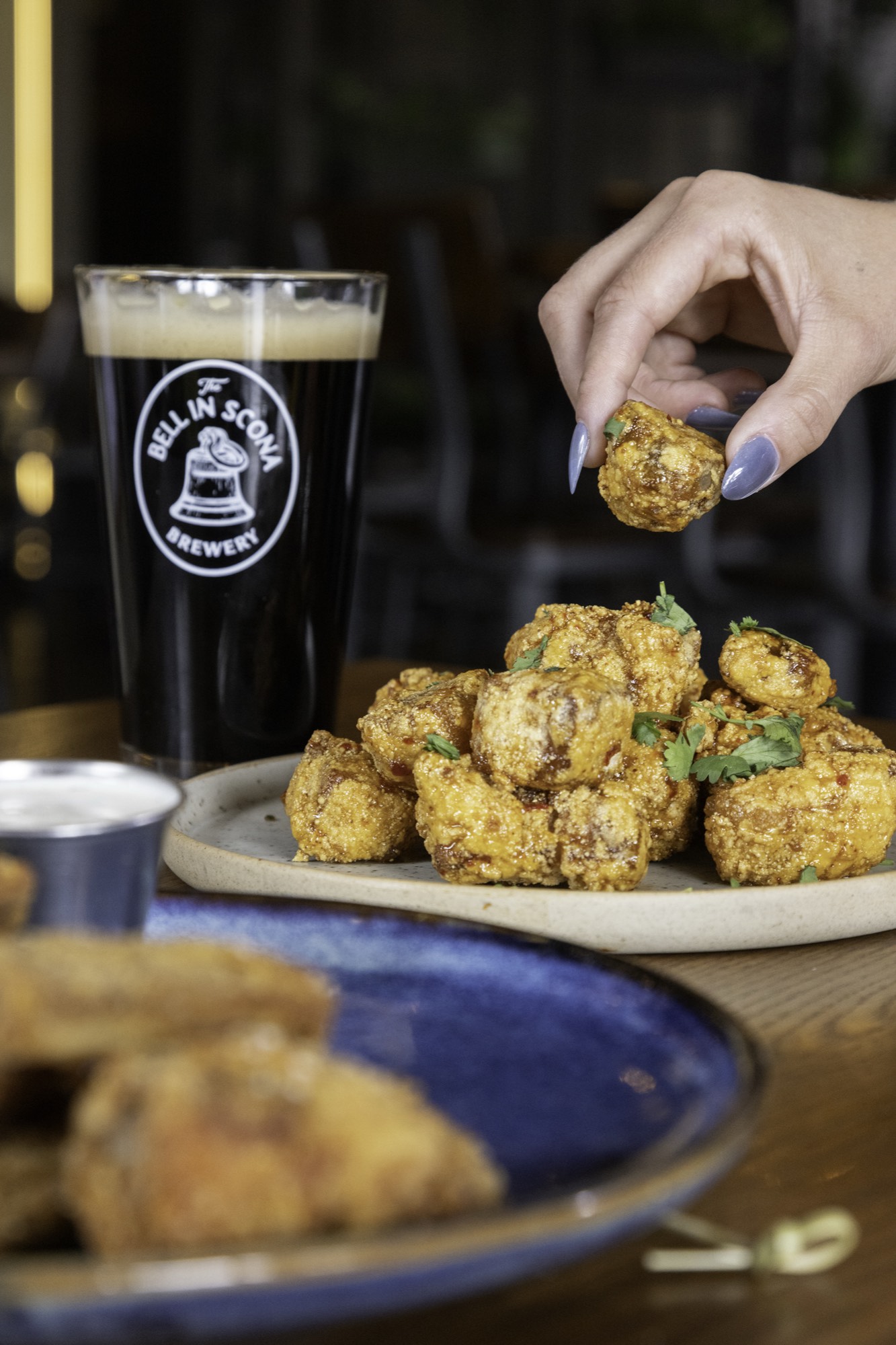 Crispy shareable bites with a pint of Bell in Scona stout