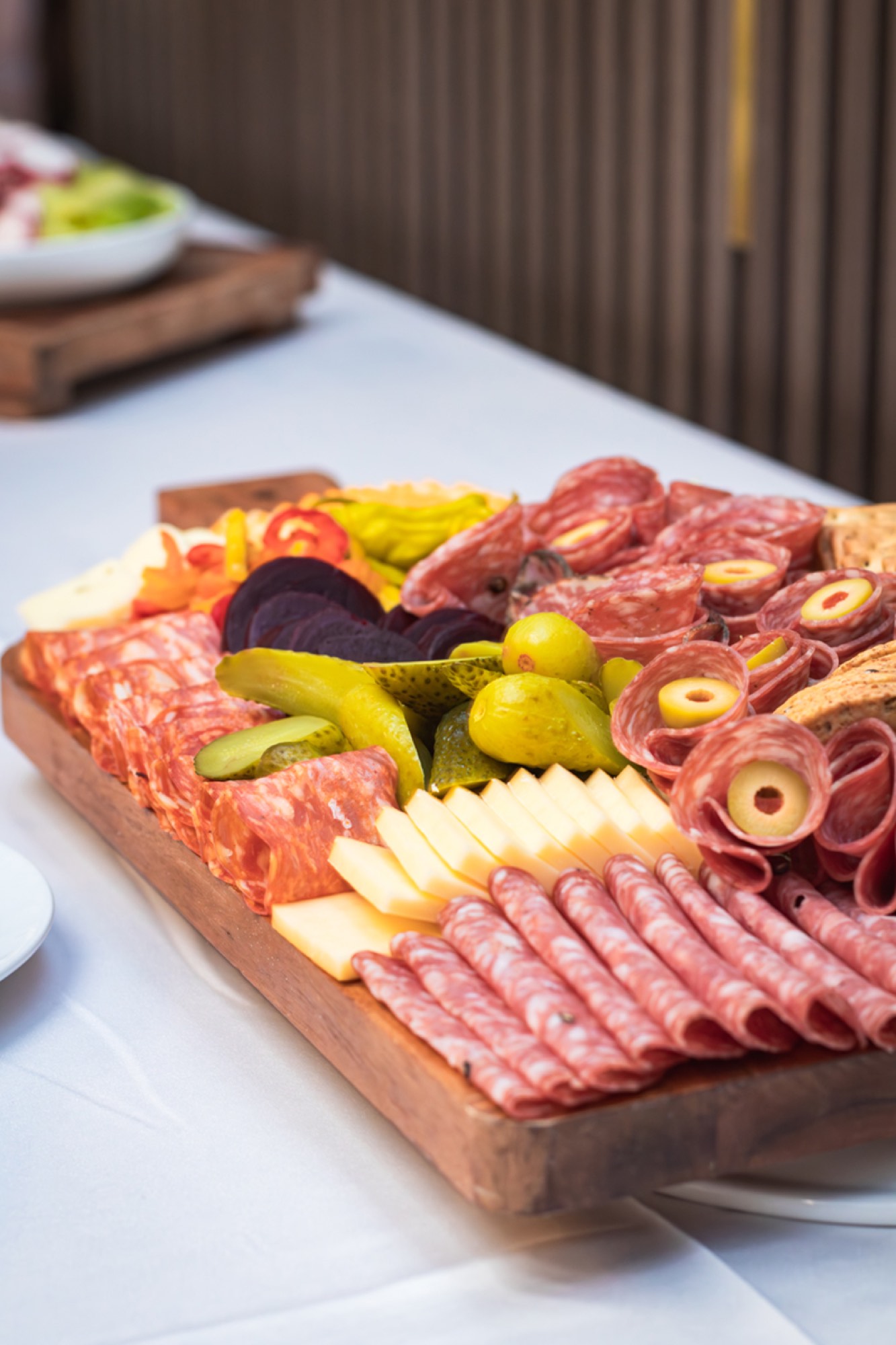 Charcuterie board with cured meats, cheeses and pickles