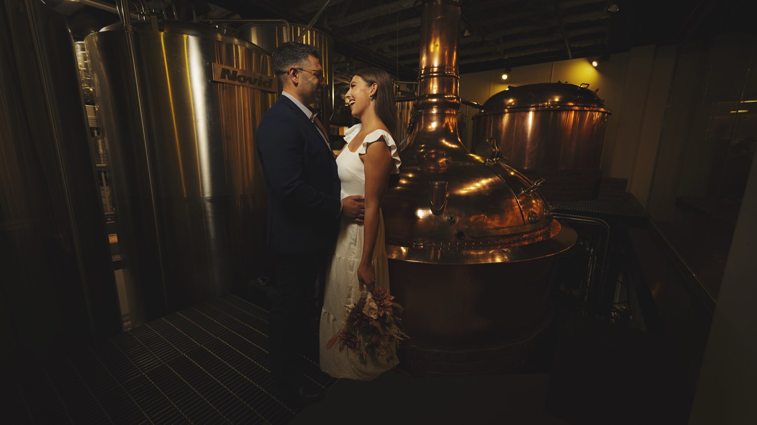 Couple by the copper brew kettle at The Bell