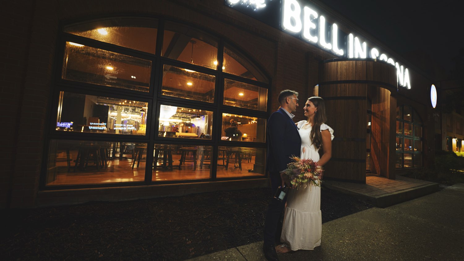Couple outside The Bell in Scona at night