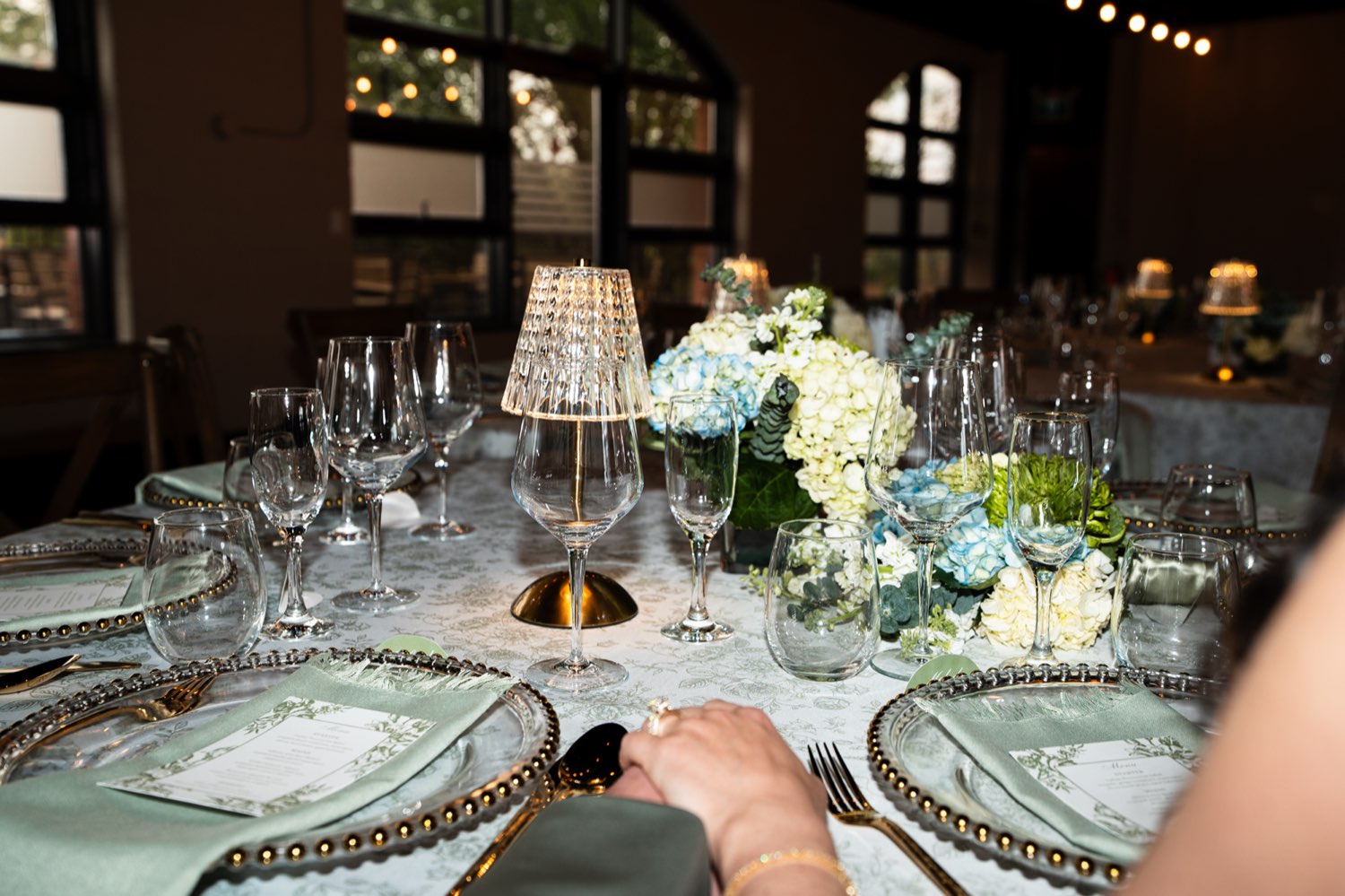 Reception table setting with green linens