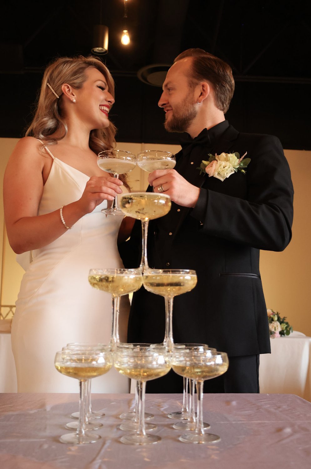 Champagne tower toast in black tie