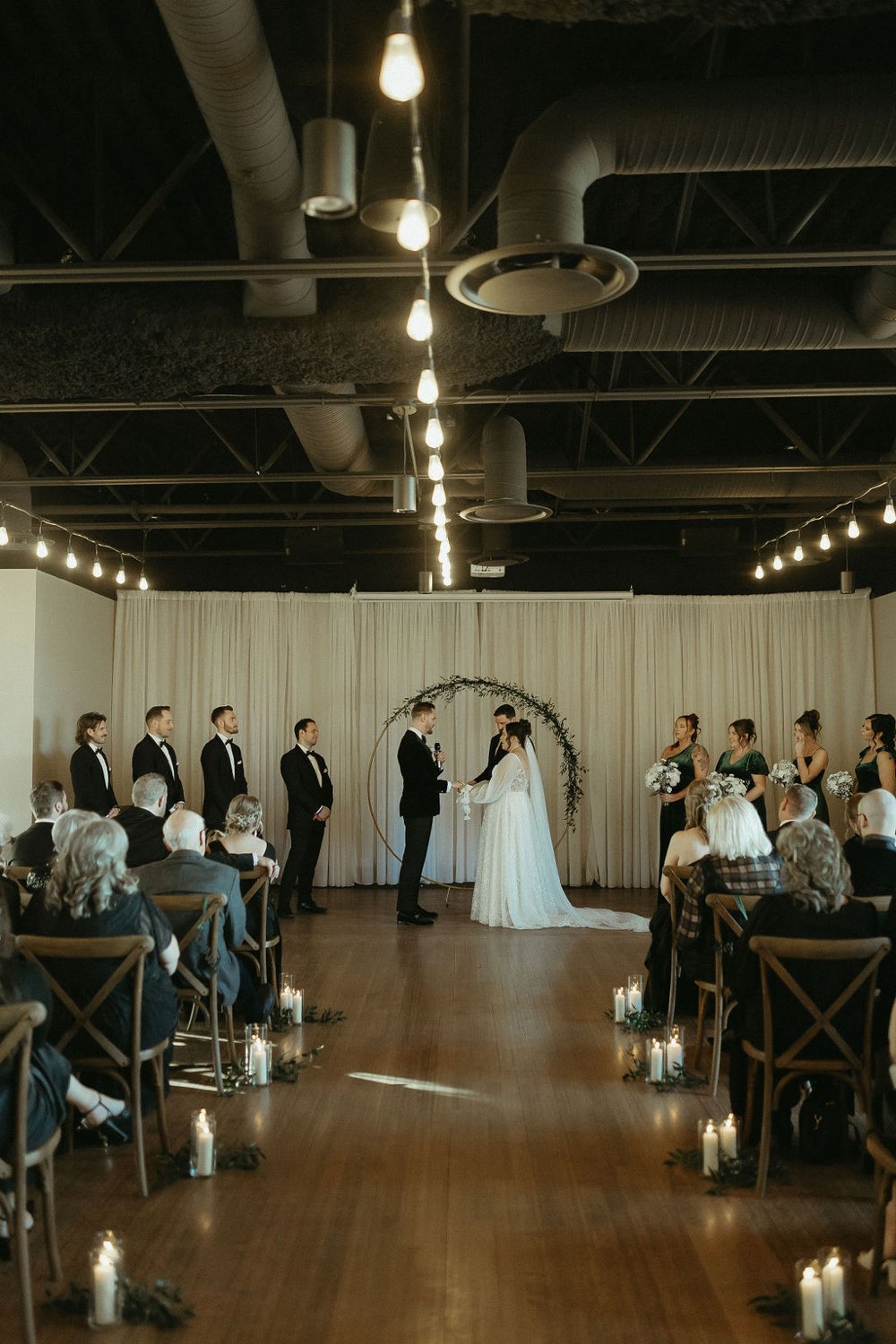 Ceremony with circular greenery arch